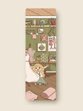 Illustrated bookmark with Celsete in a room design on a wooden surface.