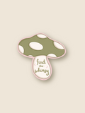 This is a sticker of a green and cream mushroom that reads "find the whimsy"