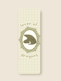 this is a green bookmark of a dragon napping